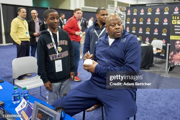 April 05: SiriusXM guest Patrick Ewing greets a fan during a break in the NCAA final Four radio broadcast on radio row at the Minneapolis Convention...