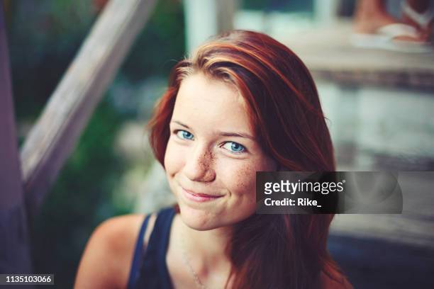 portrait of a handsome teenager with red dyed hair and blue eyes - woman blue eyes stock pictures, royalty-free photos & images