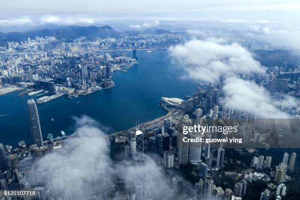 high altitude view of victoria harbour, hong kong - aerial hong kong stock-fotos und bilder