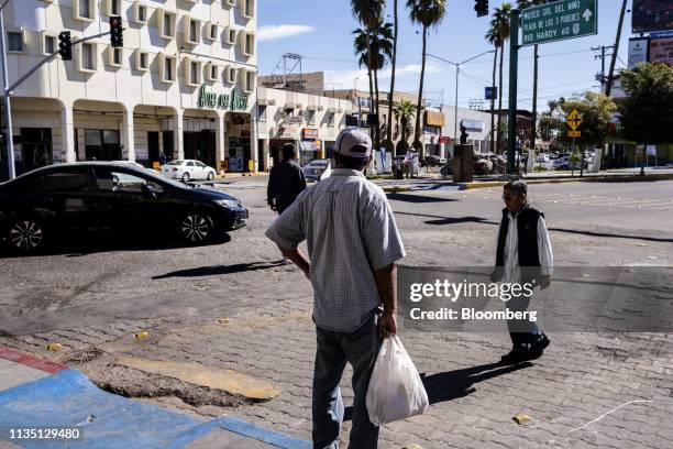 Pedestrians cross a street near the U.S.-Mexico border in Mexicali, Mexico, on Friday, April 5, 2019. U.S. President Donald Trump said the U.S. Is...