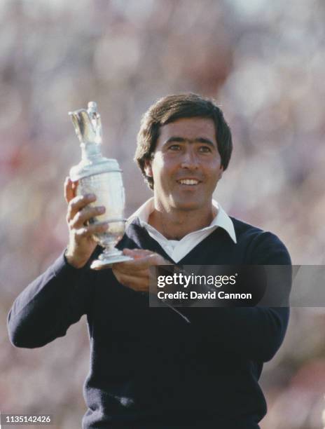 Seve Ballesteros of Spain celebrates with the Claret Jug after he holes out on the final 18th green to win the 113th Open Championship from Bernhard...