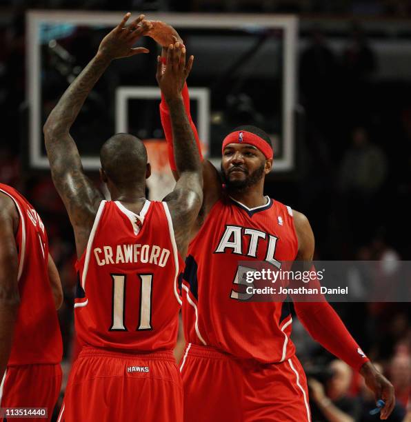 Josh Smith and Jamal Crawford of the Atlanta Hawks celebrate a win over the Chicago Bulls in Game One of the Eastern Conference Semifinals in the...