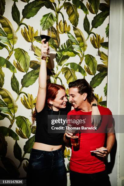 portrait of laughing couple celebrating in night club - evening indulgence stock pictures, royalty-free photos & images