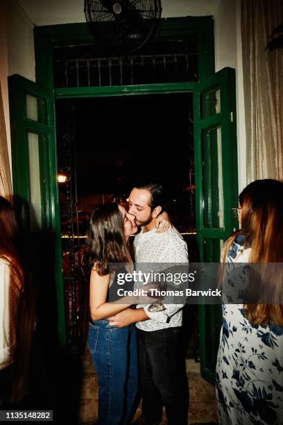 couple embracing and kissing in night club - coppia passione foto e immagini stock