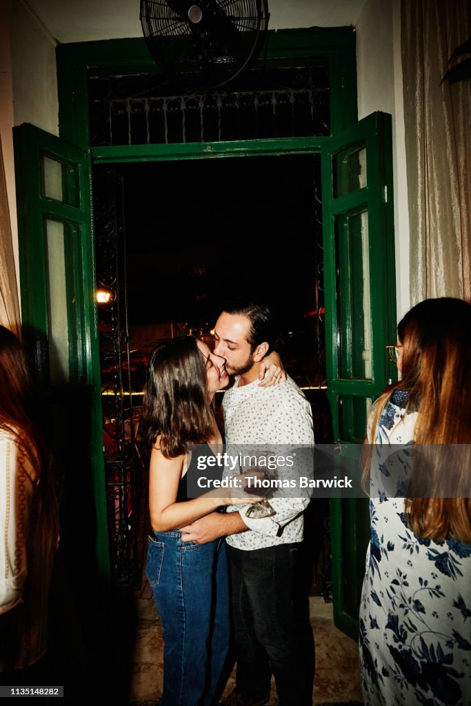 Couple embracing and kissing in night club