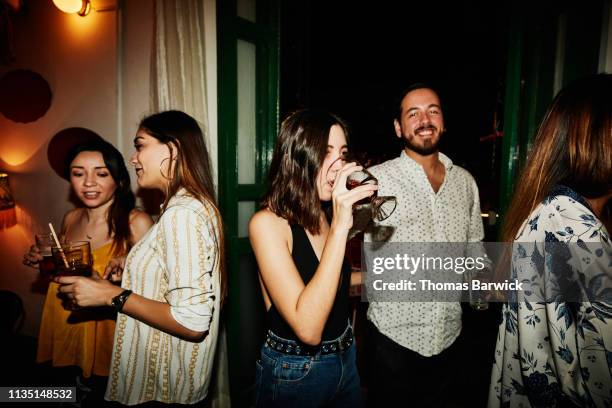 woman enjoying a drink while on date with boyfriend in night club - wine party ストックフォトと画像