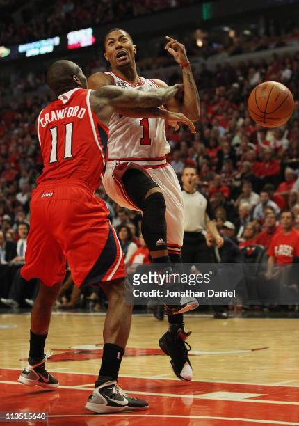 Derrick Rose of the Chicago Bulls is hit by Jamal Crawford of the Atlanta Hawks as he tries to shoot in Game One of the Eastern Conference Semifinals...