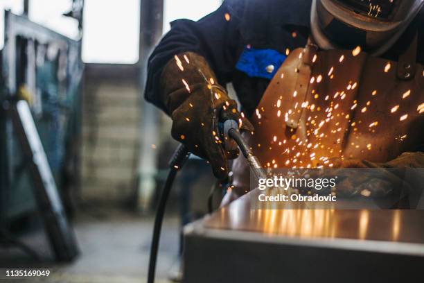 welder with welding sparks - serralheiro imagens e fotografias de stock
