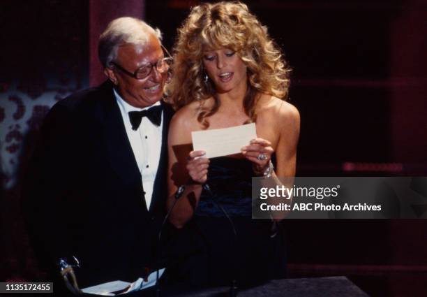 Los Angeles, CA Harold Russell, Farrah Fawcett presenting on the 52nd Academy Awards / 1980 Academy Awards, Dorothy Chandler Pavilion, April 14, 1980.