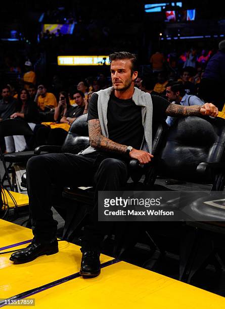 Soccer player David Beckham sits courtside before Game One of the Western Conference Semifinals in the 2011 NBA Playoffs between the Los Angeles...