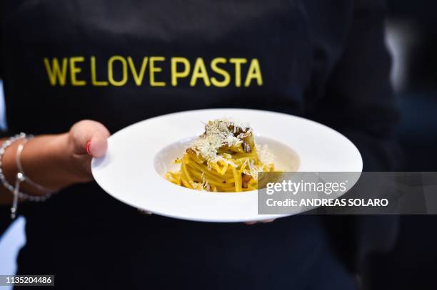 One of the chefs of the traditional team presents the traditional famous Italian pasta dish "spaghetti alla carbonara", during a preview for the...