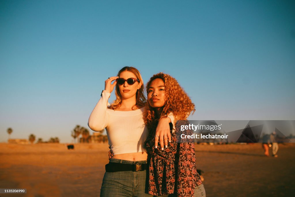 Young female friends enjoying the walk on the Venice beach in LA, California
