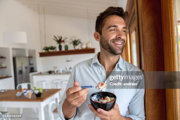 happy man eating breakfast at home - eat man stock pictures, royalty-free photos & images