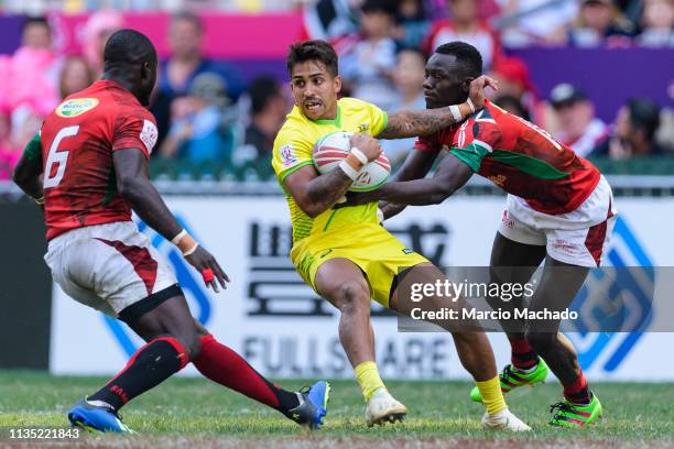 Maurice Longbottom of Australia is tackled by Jeff Oluoch of Kenya during the Pool C match between Australia vs Kenya on day two of the Cathay...