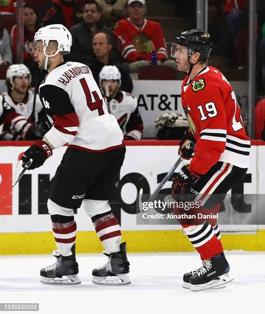 Jonathan Toews of the Chicago Blackhawks has words with Niklas Hjalmarsson of the Arizona Coyotes after Hjalmarsson knocked Toews to ice from behind...