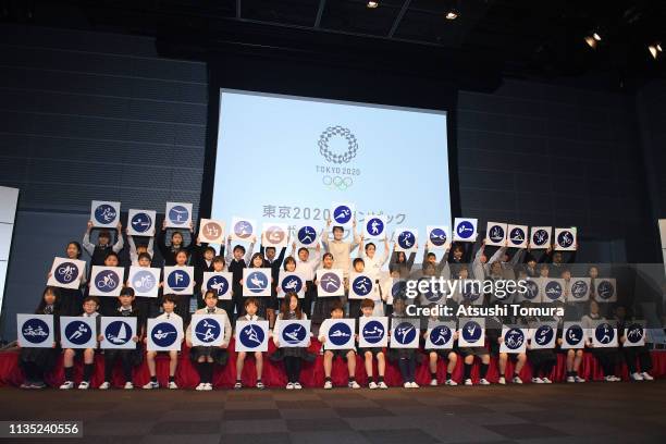 Shota Iizuka, Kiyo Shimizu of Japan and local children pose with the Tokyo 2020 olympic sport pictograms during the unveiling of the Tokyo 2020...