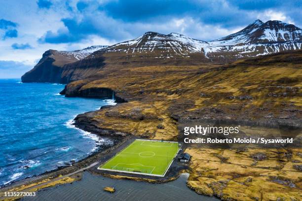 soccer field, eidi, eysturoy island, faroe islands - snow on grass stock pictures, royalty-free photos & images