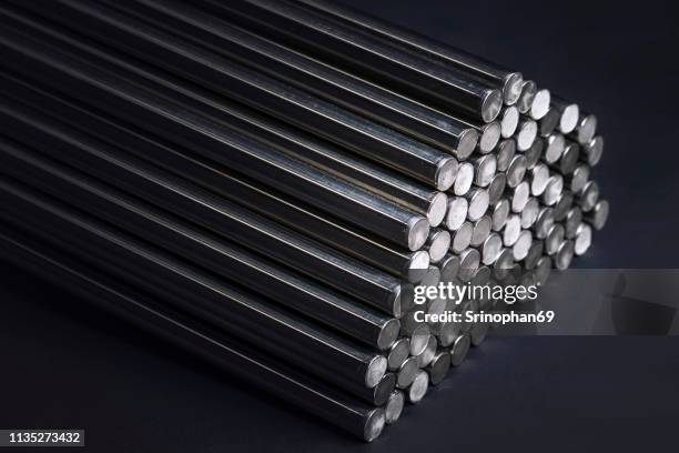 round steel bars. metallic bars on black background - tige métallique photos et images de collection