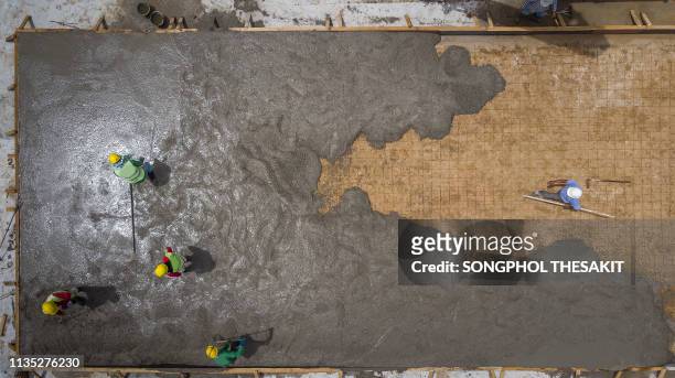 aerial shot/construction sites are pouring cement floors from skilled contractors and plasterers. - man builds his own plane imagens e fotografias de stock
