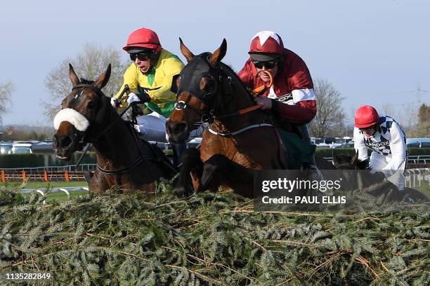 Jockey Davy Russell on Tiger Roll leads Magic Of Light riden by jockey Paddy Kennedy , to win the Grand National Handicap Chase horse race on the...