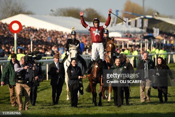 Jockey Davy Russell celebrates after riding Tiger Roll to victory in the Grand National Handicap Chase horse race on the final day of the Grand...