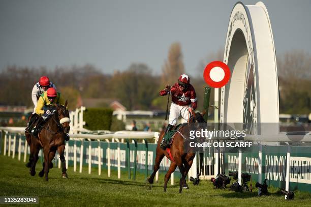 Jockey Davy Russell on Tiger Roll competes to win ahead of Magic Of Light riden by jockey Paddy Kennedy and Rathvinden riden by jockey Ruby Walsh, to...