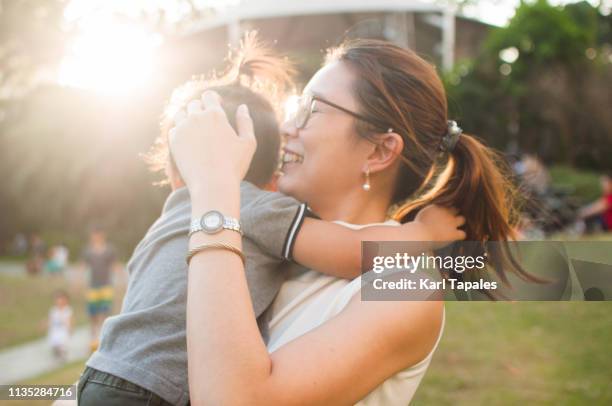a portrait of a mother and child outdoor - philippines family stock pictures, royalty-free photos & images