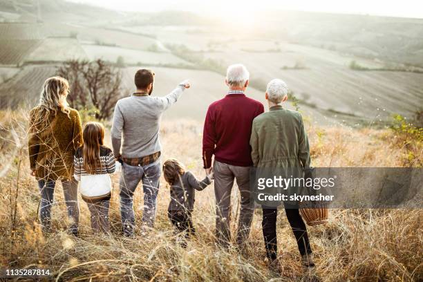 we should make a picnic over there! - multi generation family from behind stock pictures, royalty-free photos & images