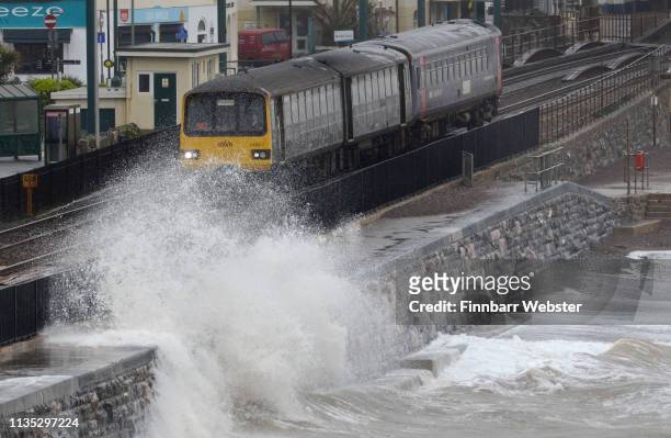 Waves crash against the seafront and railway line on March 12, 2019 in Dawlish, United Kingdom. Met Office issues yellow warnings as Storm Gareth is...