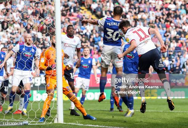 Bolton Wanderers' Will Buckley heads at goal under pressure from Ipswich Town's Myles Kenlock during the Sky Bet Championship match between Bolton...