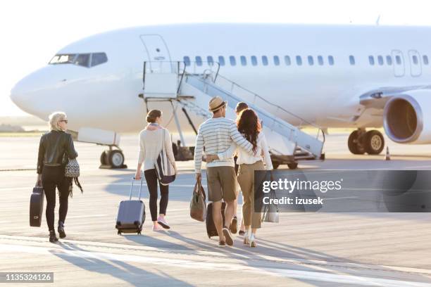 passengers boarding a flight - getting on stock pictures, royalty-free photos & images