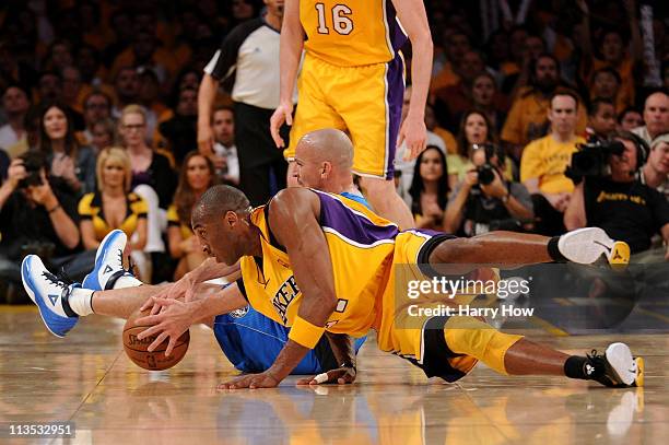 Jason Kidd of the Dallas Mavericks and Kobe Bryant of the Los Angeles Lakers battle for a loose ball in the third quarter in Game One of the Western...