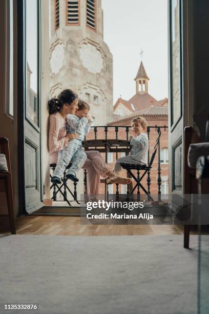 family on balcony - family holidays hotel stockfoto's en -beelden