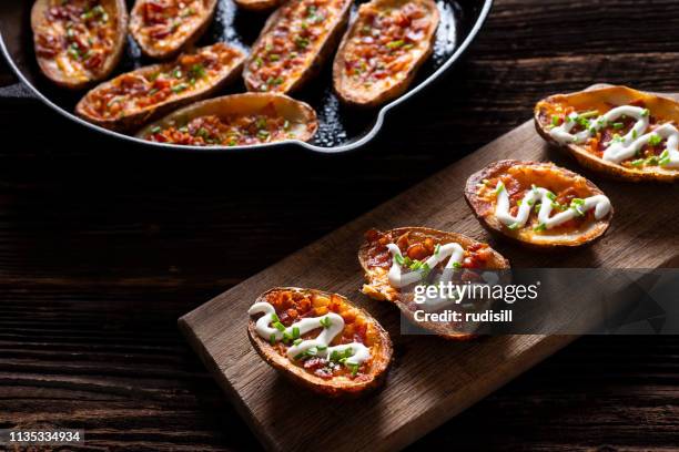 loaded potato skins - stuffed potato stock pictures, royalty-free photos & images