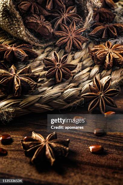 close-up of star anise in a group coming out from a serving scoop - star anise stock pictures, royalty-free photos & images