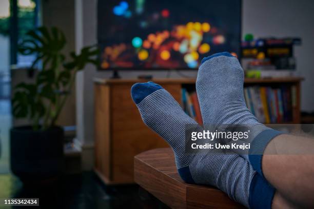person watching tv - men socks foto e immagini stock