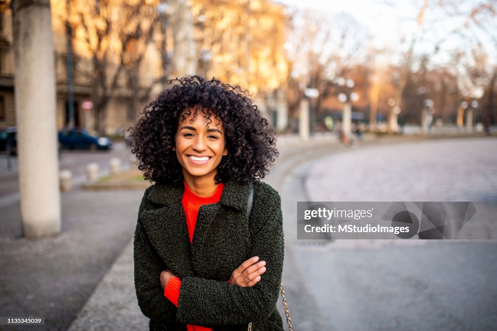 Portrait of smiling woman looking at camera.