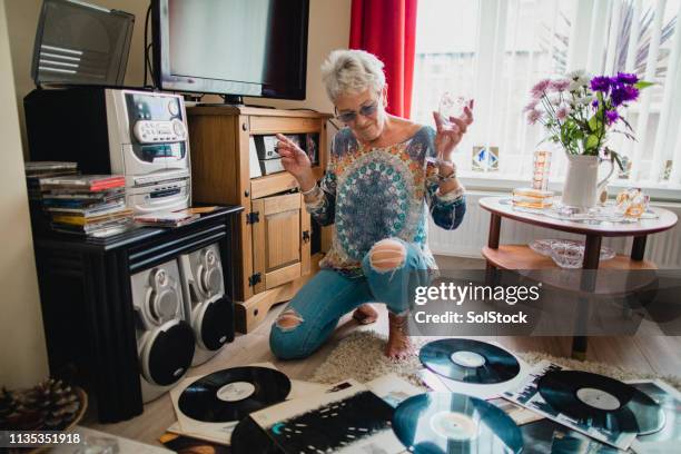 she loves listening to vinyl records - carefree senior stock pictures, royalty-free photos & images