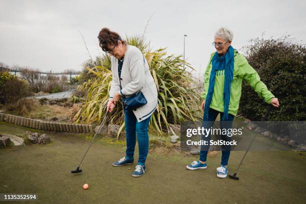 having fun at the mini gold course - mini golf stock pictures, royalty-free photos & images