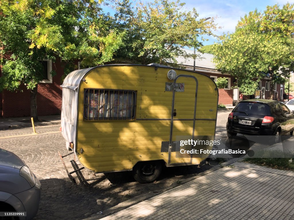 Yellow camper trailer in the street