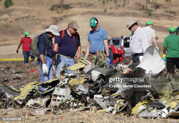 Investigators with the U.S. National Transportation and Safety Board look over debris at the crash site of Ethiopian Airlines Flight ET 302 on March...