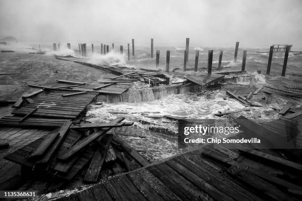 Portions of a boat dock and boardwalk are destroyed by powerful wind and waves as Hurricane Florence arrives September 13, 2018 in Atlantic Beach,...