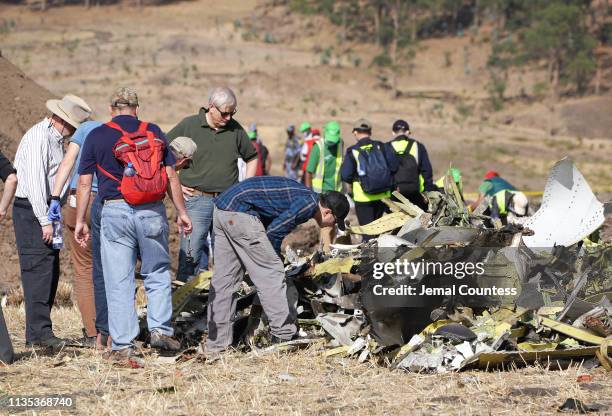 Investigators with the U.S. National Transportation and Safety Board look over debris at the crash site of Ethiopian Airlines Flight ET 302 on March...