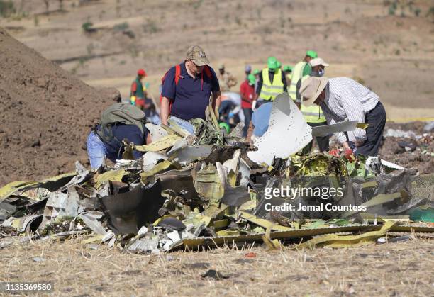 Investigators with the U.S. National Transportation and Safety Board look over debris at the crash site of Ethiopian Airlines Flight ET 302 on March...