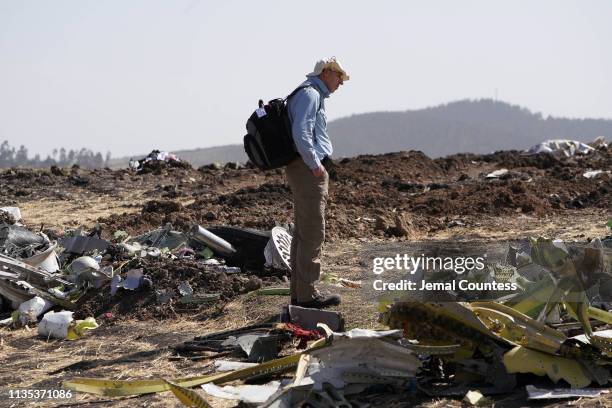 An investigator with the U.S. National Transportation and Safety Board looks over debris at the crash site of Ethiopian Airlines Flight ET 302 on...