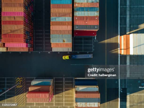 aerial shot of truck in container terminal from directly above - shipping container stock pictures, royalty-free photos & images