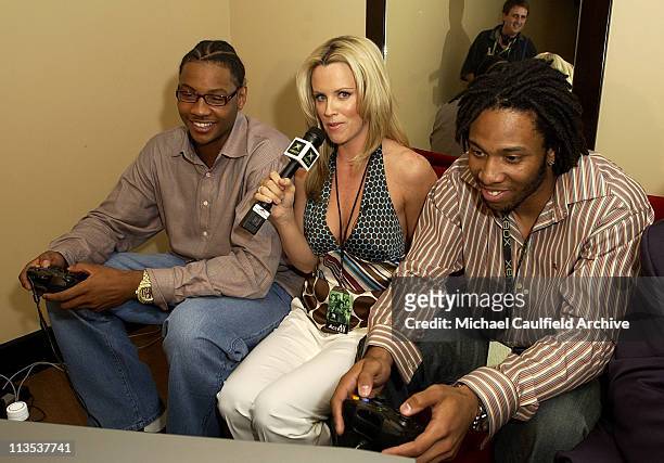 Carmelo Anthony, Jenny Mcarthy and Larry Fitzgerald try out an Xbox title during Xbox's E3 press briefing at the Shrine Auditorium, Monday May 10,...