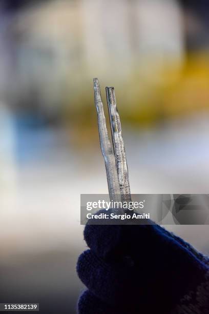 hand holding broken icicles - icicle macro stock pictures, royalty-free photos & images