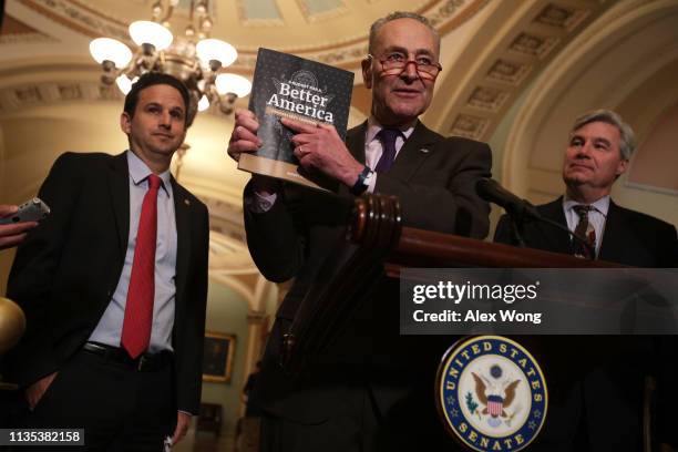 Senate Minority Leader Sen. Chuck Schumer holds up a copy of U.S. President Donald Trump's FY2020 budget request as Sen. Brian Schatz and Sen....