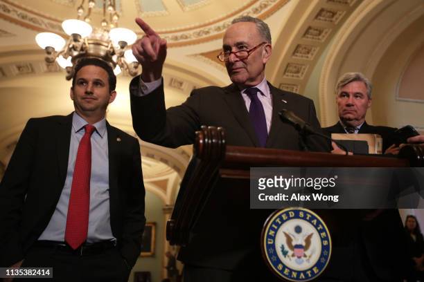 Senate Minority Leader Sen. Chuck Schumer takes questions as Sen. Brian Schatz and Sen. Sheldon Whitehouse look on during a news briefing after the...